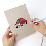 Punching a Little City Cars mini canvas with the punch needle