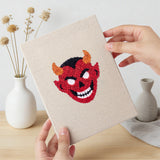 Hand holding a finished Little Devils mini canvas