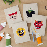 The four finished Little Devils mini canvases laid out on a table