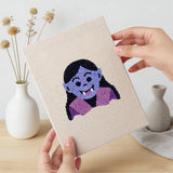 Hand holding a finished Little Vampire mini canvas