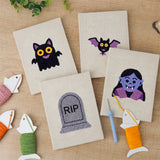 The four finished Little Vampire mini canvases laid out on a table