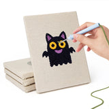 Hand punching one of the Little Vampire mini canvases