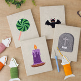 The four finished Lollipop and Bat mini canvases laid out on a table