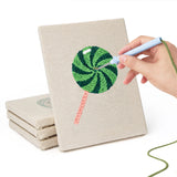 Hand punching one of the Lollipop and Bat mini canvases