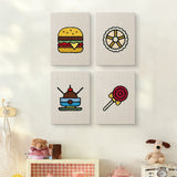 The four Lollipop Lunch mini canvases on a wall above a shelf