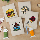 The four finished Lollipop Lunch mini canvases laid out on a table