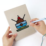 Punching a Lollipop Lunch mini canvas with the punch needle