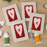 The four finished Love Letter Hearts mini canvases laid out on a table