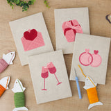 The four finished Love Letter Pink mini canvases laid out on a table