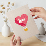 Hand holding a finished Love Note Hearts mini canvas