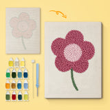 Magenta Bloom canvas before and after punching, with the threads and tools
