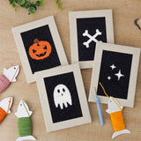 The four finished Midnight Ghost mini canvases laid out on a table