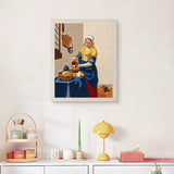 Finished Milkmaid at Window punch needle canvas on a wall