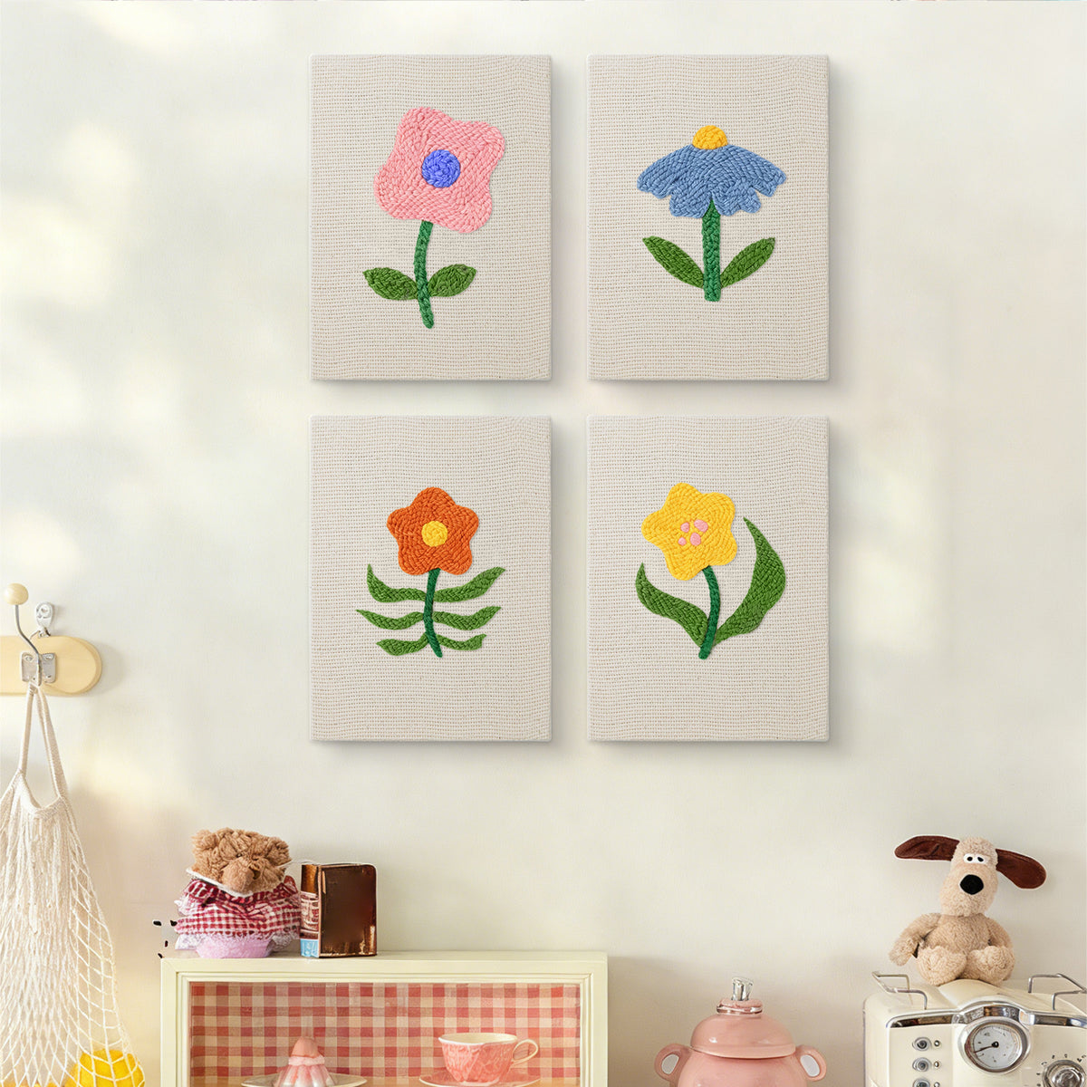 The four Mixed Meadow Blooms mini canvases on a wall above a shelf