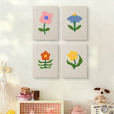 The four Mixed Meadow Blooms mini canvases on a wall above a shelf