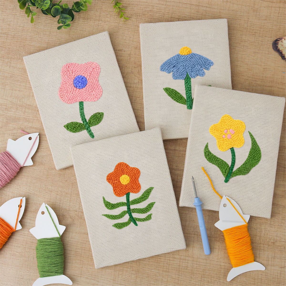 The four finished Mixed Meadow Blooms mini canvases laid out on a table