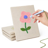 Hand punching one of the Mixed Meadow Blooms mini canvases