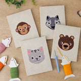 The four finished Monkey and Wolf mini canvases laid out on a table