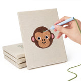 Hand punching one of the Monkey and Wolf mini canvases