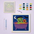 Monster Bath Time canvas before and after punching, with the threads and tools