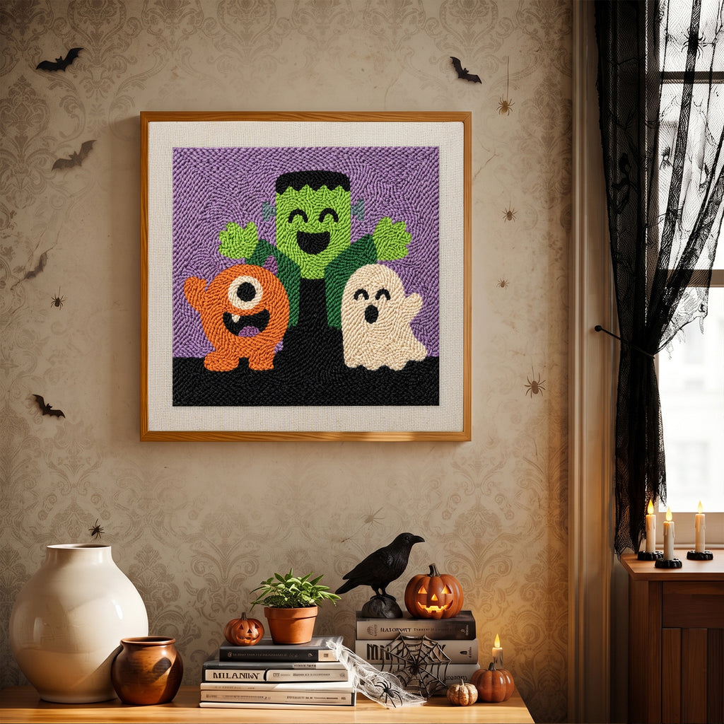 Finished Monster Trio punch needle canvas on a wall