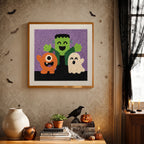 Finished Monster Trio punch needle canvas on a wall