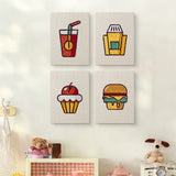 The four Movie Night Snacks mini canvases on a wall above a shelf