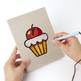 Punching a Movie Night Snacks mini canvas with the punch needle