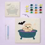 Mummy Bubble Bath canvas before and after punching, with the threads and tools