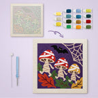 Mummy Mushrooms canvas before and after punching, with the threads and tools