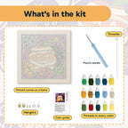 What is in the Mummy Pumpkin Cat kit: printed canvas, punch needle, threader, threads, color guide and hangers