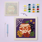 Mummy Pumpkin Cat canvas before and after punching, with the threads and tools