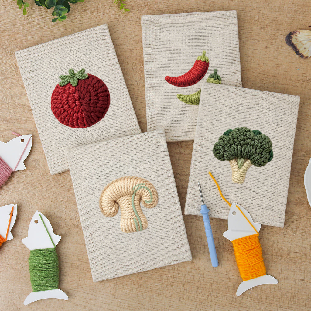 The four finished Mushroom and Chilies mini canvases laid out on a table
