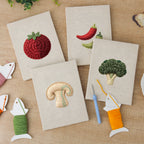 The four finished Mushroom and Chilies mini canvases laid out on a table