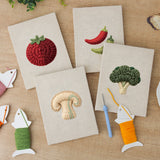 The four finished Mushroom and Chilies mini canvases laid out on a table