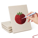 Hand punching one of the Mushroom and Chilies mini canvases