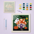Mushroom House Ghost canvas before and after punching, with the threads and tools