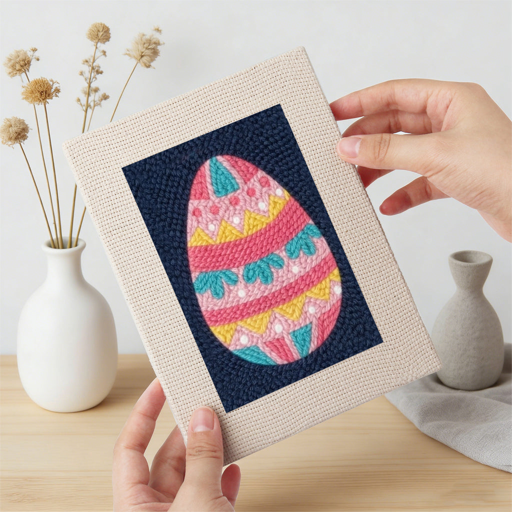 Hand holding a finished Navy Easter Eggs mini canvas