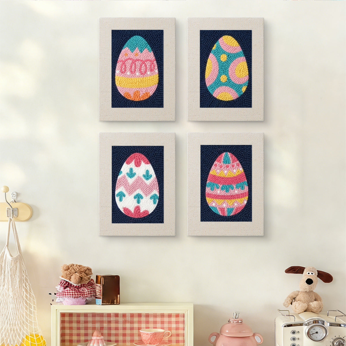 The four Navy Easter Eggs mini canvases on a wall above a shelf