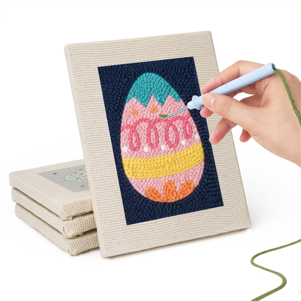 Hand punching one of the Navy Easter Eggs mini canvases