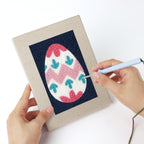 Punching a Navy Easter Eggs mini canvas with the punch needle