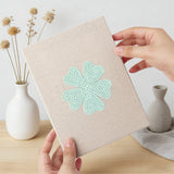 Hand holding a finished Navy Mint Blooms mini canvas