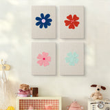The four Navy Mint Blooms mini canvases on a wall above a shelf