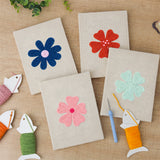 The four finished Navy Mint Blooms mini canvases laid out on a table