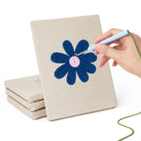 Hand punching one of the Navy Mint Blooms mini canvases