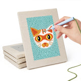 Hand punching one of the Navy Teal Cats mini canvases