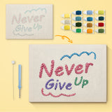 Never Give Up canvas before and after punching, with the threads and tools