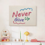 Finished Never Give Up punch needle canvas on a wall