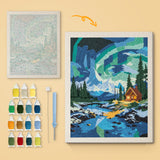 Northern Lights Cabin canvas before and after punching, with the threads and tools