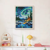 Finished Northern Lights Cabin punch needle canvas on a wall
